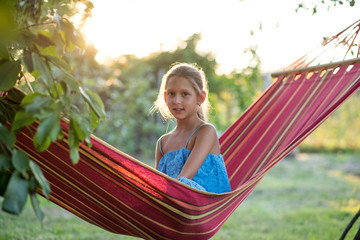 young woman reading a book in the park