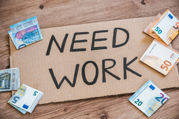 "Need work " sign and euros. Economic crisis  / unemployment concept.
