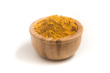 Curry Powder into a wooden bamboo bowl