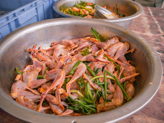 Raw Chicken wings marinated with chili and vegetables in chinese food at shantou city China Guangdong.