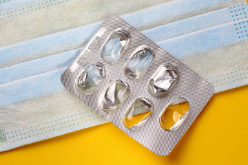 Medical mask and blister without pills. Background on the epidemic and pandemic, viral...