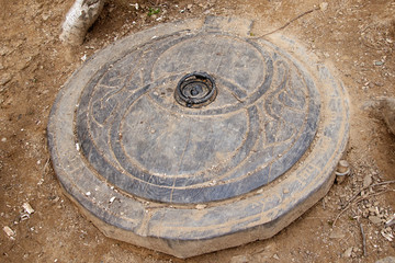 Wood carving made to look like drain cover