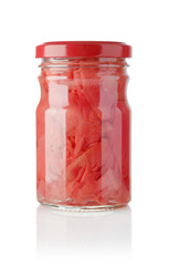 Pickled ginger in a glass jar on a white