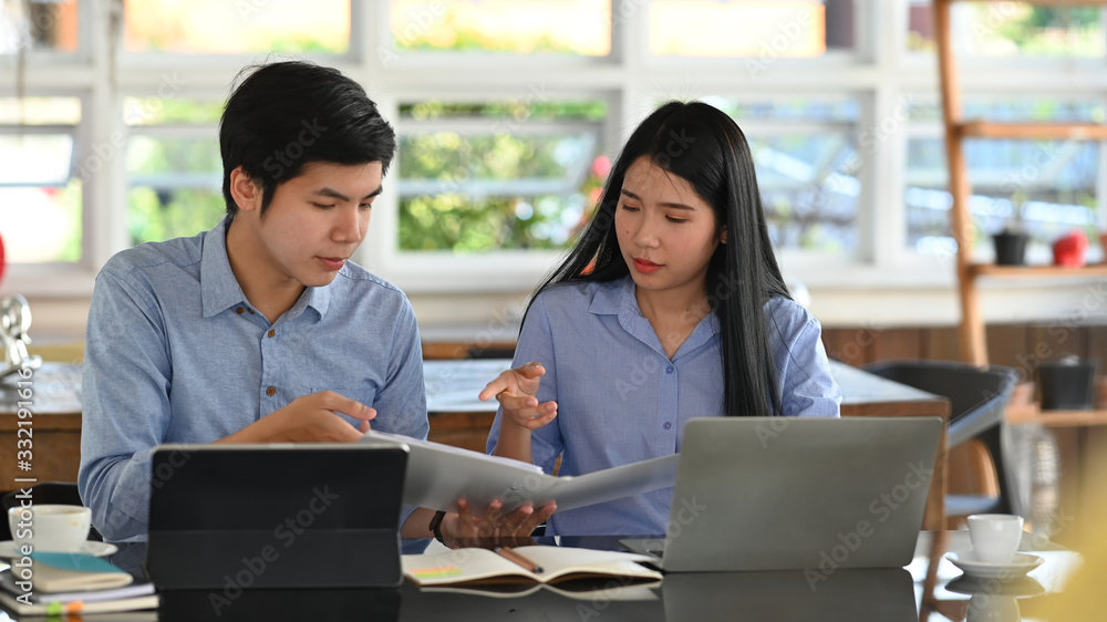 Poster cropped image of business developer team discussing/talking/working together with computer tablet, l