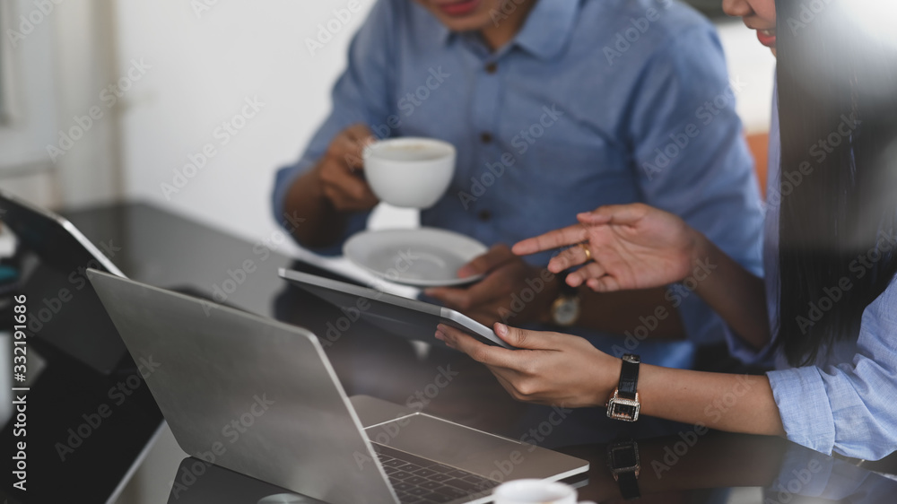 Poster cropped image of business developer team working together by using a computer tablet and laptop whil