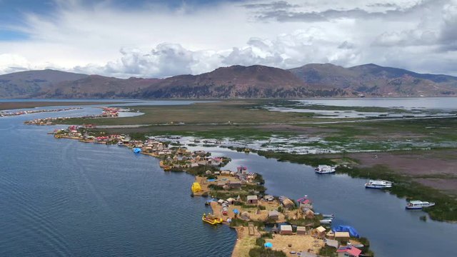 Aerial view of Uros Floating Islands (Spanish: Islas Uros ) on Lake Titicaca, the highest navigable lake in the world, on the border of Peru and Bolivia, South America.