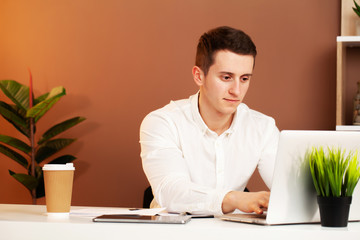 Employee works at the computer in office