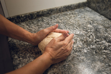 Hands making bread doe. A POV shot