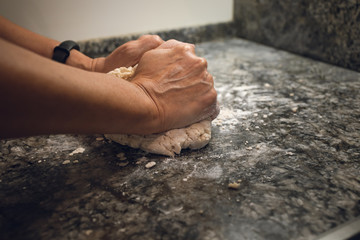 Hands making bread doe. A POV shot