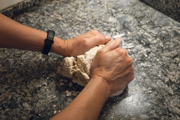 Hands making bread doe. A POV shot