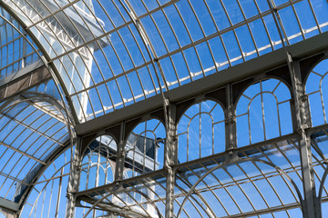 interior of greenhouse in garden with transparent glass roof.