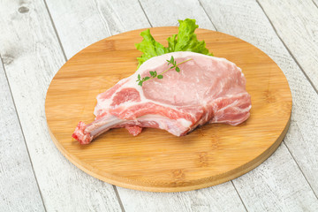 Raw pork bone steak over wooden