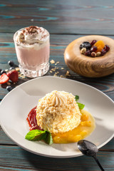 Cake Napoleon puff pastry dessert with strawberry and mango sauce and strawberry milkshake on wooden table
