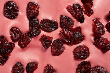 A bar of pink chocolate with cranberries close-up