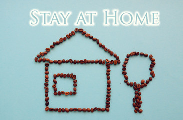 house from coffee beans  on a blue background staying at home with self quarantine to help slow outbreak and protect virus spread