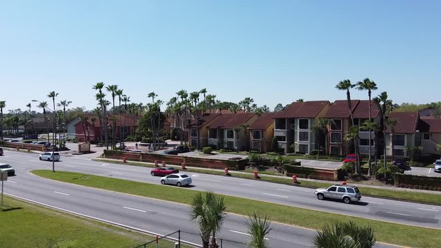 Ascending Aerial Over Traffic In Tropical Vacation Destination With Palm Trees