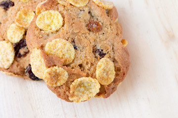 Close up view of cereal cookie on wooden table. Freshly baked oat biscuit.