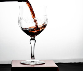red wine pouring into glass