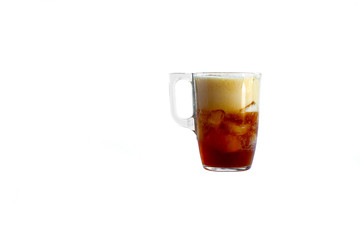 a mug is poured into it. Added ice cubes. Close-up. Deign on a white background