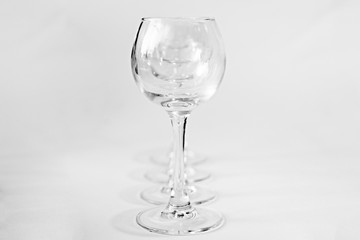 a row of glass transparent glasses on a white background, isolate