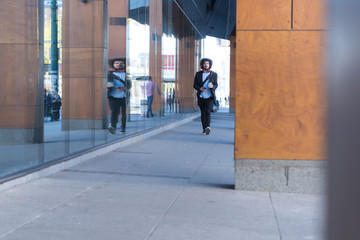 Portrait Of young Businessman  Outside Office. Meeting Concept. Man Walking and drinking coffe, going to the office.