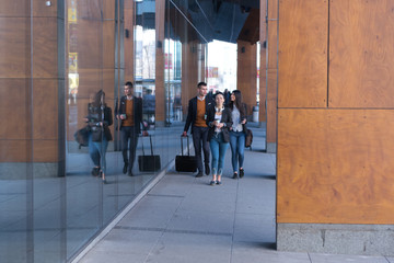 Portrait Of Business Team Outside Office. Meeting Concept. People Walking and drinking coffe, going to the office.