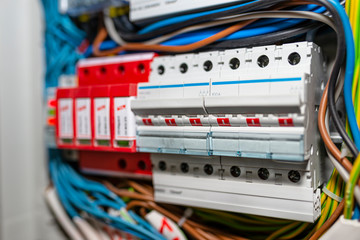 Three-phase fuse in the ON position and surge arrester used to protect the electrical system in the building during electrical discharges, storm protection.