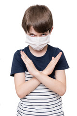Portrait of young boy wearing face mask shows stop hands gesture for coronavirus outbreak, isolated on white background