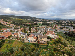 Aerial view of upper middle class neighborhood with residential subdivision houses during clouded day in San Diego, California, USA.