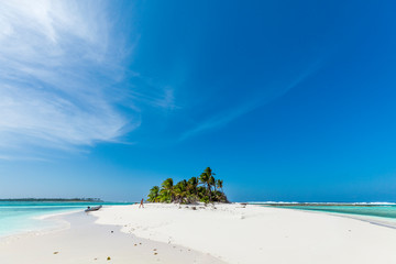 tiny little sandy island with palm tree and white sand beach in the turquoise lagoon of Cocos Keeling atollm landscapephotography