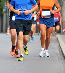 runners with shorts and sneakers on the road