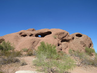 View of Hole-in-the-Rock in Papago Park, located in Phoenix and Tempe, Arizona with blue sky in the background 