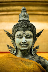 Photo of a beautiful statue with a bright gold background in Bangkok
