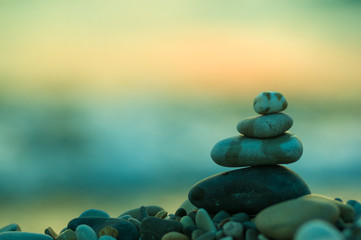 stack of zen stones on pebble beach