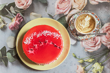 Light strawberry yogurt cake with a Cup of cappuccino on the table on a tablecloth with roses