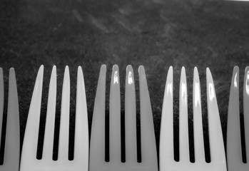 plastic kitchen eating utensils in a row