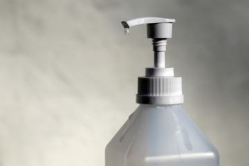 Corona virus hand sanitizer bottle dispensing rubbing alcohol gel for hands hygiene health care prevention.