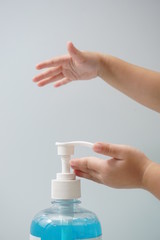 Child hand picks soap or sanitizer for personal hygiene measures.