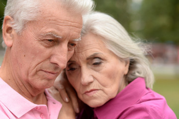 Close up portrait of unhappy senior couple