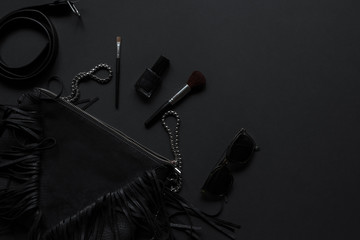 Accessories for women's beauty. Black monochromatic composition on black background.Minimalist...