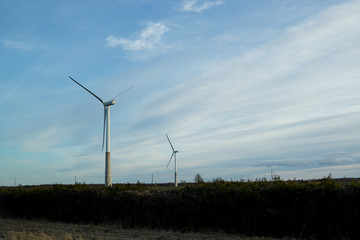 Wind Turbines in wind farm against cloudy sky.Eletric Power Generator Wind Turbine over Sky.renewable electric energy production.Eco power, wind turbines.Selective focus.Copy space