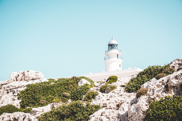 Fototapeta na wymiar Faro de Menorca en verano acantilados y atardecer