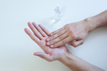 Man hand using wash hand sanitizer gel pump dispenser for protection coronavirus, germ and...