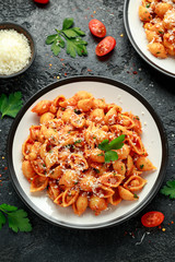 Conchiglie rigate pasta with chickpeas in tomato sauce with parmesan cheese. Healthy vegan food.