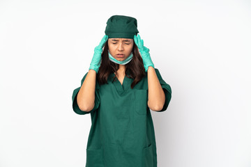 Surgeon woman in green uniform isolated on white background with headache