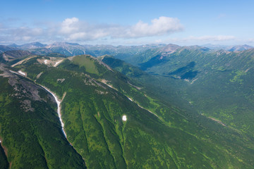 Fototapeta premium aerial view of Kamchatka volcanos, green valleys, snow and ice and the wonderful view of pure nature.
