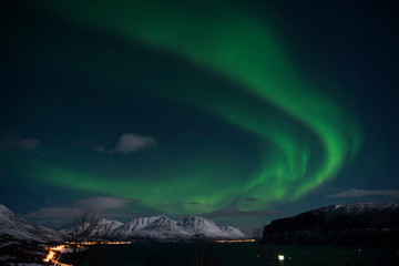 Northern light over fjord and mountain in arctic Norway.