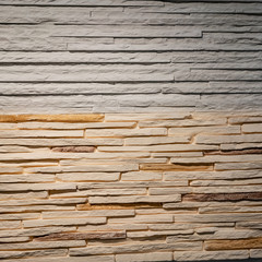 wall with textured surface made of stone clinker tiles, gray-brown color