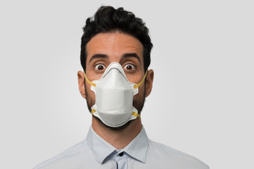 Surprised dark-haired man with medical face mask