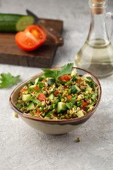 Healthy salad with mung beans, tomatoes, cucumber, lettuce and greens